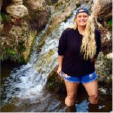 Candid photo of a woman in front of a waterfall